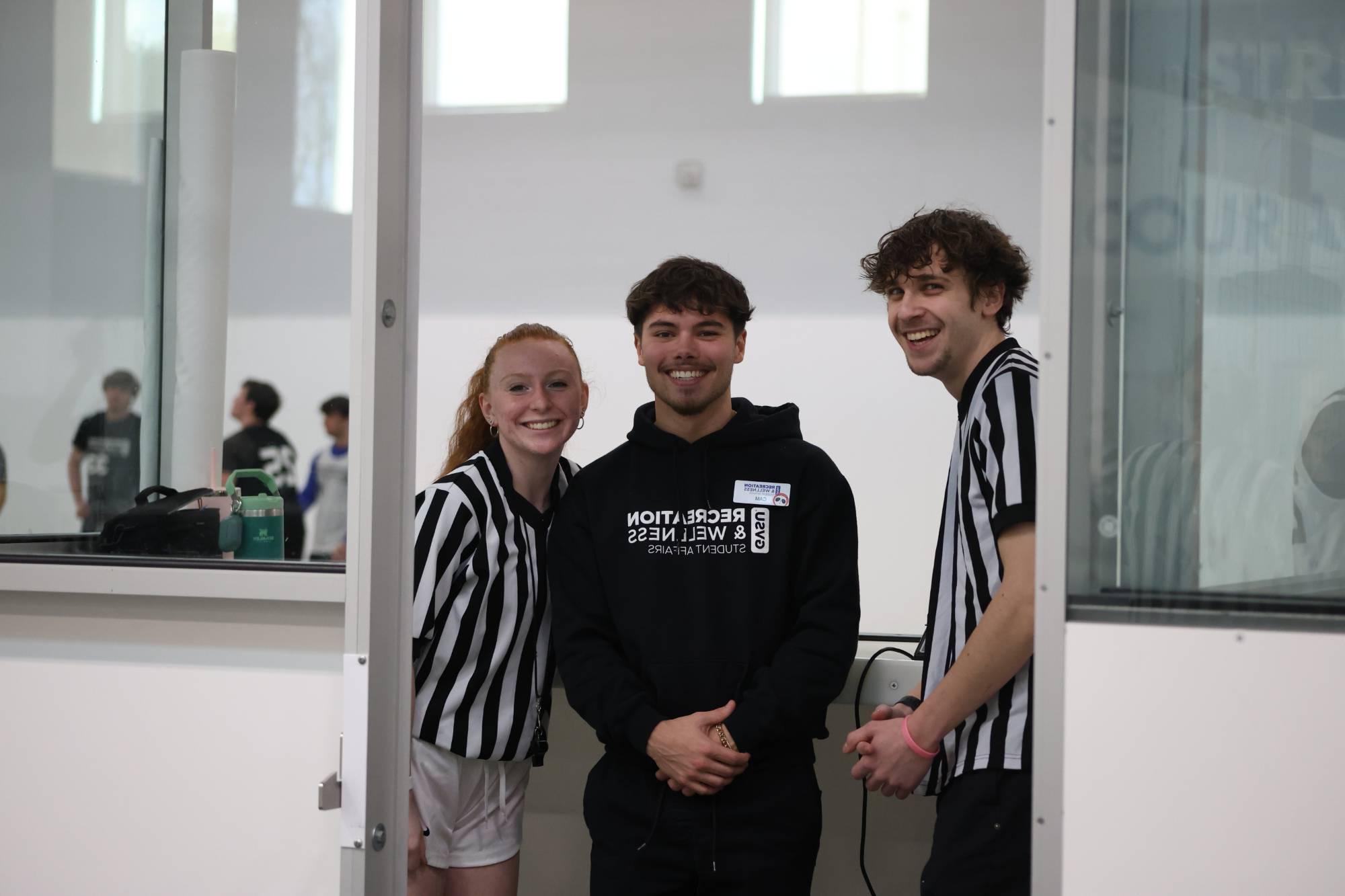 RecWell Student Staff at intramural sports. From left to right: referee, supervisor, referee